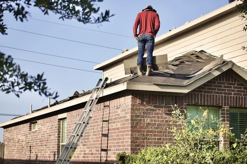 Professional roofer working on a residential roof in Chest Springs